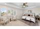 Bright main bedroom with white walls, plush carpet, large windows, and a ceiling fan provides a relaxing retreat at 1265 S Sherman St, Denver, CO 80210