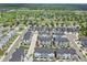 Modern townhouse community boasts black roofs, light exteriors, sidewalks, and green spaces at 5387 Pierson Ct, Wheat Ridge, CO 80033