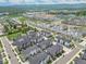 An aerial view of townhouses features modern architecture, sidewalks, landscaping, and nearby green spaces at 5387 Pierson Ct, Wheat Ridge, CO 80033