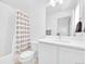Bright bathroom with a shower-tub combo and modern vanity at 5387 Pierson Ct, Wheat Ridge, CO 80033