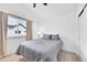 Comfortable bedroom featuring a cozy bed and natural light from the window at 5387 Pierson Ct, Wheat Ridge, CO 80033