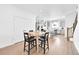 Bright dining area with a light wood table, kitchen island and modern gray cabinets at 5387 Pierson Ct, Wheat Ridge, CO 80033