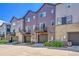 Three-story townhomes feature modern exteriors with stone accents, private balconies, and attached garages at 5387 Pierson Ct, Wheat Ridge, CO 80033