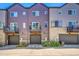Townhome exteriors with garage, balcony, and modern architectural details at 5387 Pierson Ct, Wheat Ridge, CO 80033
