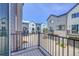 View from the balcony showing a row of modern townhomes with blue sky overhead at 5387 Pierson Ct, Wheat Ridge, CO 80033
