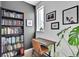 Cozy home office with a bookshelf, desk, chair, and natural light from a window at 5387 Pierson Ct, Wheat Ridge, CO 80033