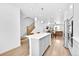 Open floor plan showcases a kitchen island and stainless steel refrigerator at 5387 Pierson Ct, Wheat Ridge, CO 80033