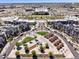 Aerial view of a mixed-use residential and retail community with ample parking at 10360 E 57Th Pl, Denver, CO 80238