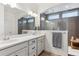 Bathroom with double sinks, shower with tile surround and modern fixtures at 10360 E 57Th Pl, Denver, CO 80238