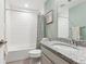 Bathroom featuring granite countertops, tiled walls and floors, plus a tub and shower at 10360 E 57Th Pl, Denver, CO 80238