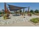 Community courtyard with overhead shade and floral landscaping with benches at 10360 E 57Th Pl, Denver, CO 80238