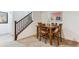 Cozy dining area featuring a wooden table with four chairs, steps, and modern artwork at 10360 E 57Th Pl, Denver, CO 80238