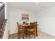 Comfortable dining area with wooden table, four chairs, and stylish decorative artwork at 10360 E 57Th Pl, Denver, CO 80238