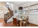 Dining room featuring wood floors, modern lighting and staircase access to upper level at 10360 E 57Th Pl, Denver, CO 80238