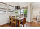 Bright dining area featuring wood floors, modern lighting and multiple windows with woven shades at 10360 E 57Th Pl, Denver, CO 80238