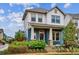Charming two-story home with a beautifully landscaped front yard and inviting porch at 10360 E 57Th Pl, Denver, CO 80238