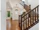 Elegant foyer with hardwood floors, staircase, and stylish lighting at 10360 E 57Th Pl, Denver, CO 80238
