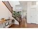 Welcoming foyer with hardwood floors, staircase, and modern decor at 10360 E 57Th Pl, Denver, CO 80238