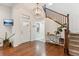Bright and airy foyer with a view of the staircase and front door at 10360 E 57Th Pl, Denver, CO 80238
