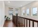 Hallway with wood floors and large windows for natural light at 10360 E 57Th Pl, Denver, CO 80238