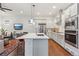 Spacious kitchen featuring white cabinets, stainless steel appliances and an open concept design at 10360 E 57Th Pl, Denver, CO 80238