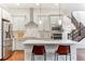 Open kitchen featuring stainless appliances, an island with seating and modern finishes at 10360 E 57Th Pl, Denver, CO 80238