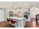 Well-lit kitchen features a large island, stainless appliances, and stylish pendant lighting at 10360 E 57Th Pl, Denver, CO 80238