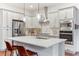 Modern kitchen with stainless steel appliances, a large island and designer backsplash at 10360 E 57Th Pl, Denver, CO 80238