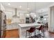 Bright kitchen featuring a large island, modern appliances and an attached dining area at 10360 E 57Th Pl, Denver, CO 80238