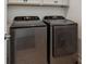 Modern laundry room with front-loading washer and dryer in a sleek design at 10360 E 57Th Pl, Denver, CO 80238