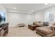 Spacious living room with sectional sofa, TV, and coffee table on carpeted floor at 10360 E 57Th Pl, Denver, CO 80238