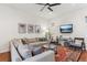 Bright living room with ceiling fan, comfortable seating and a stylish rug at 10360 E 57Th Pl, Denver, CO 80238