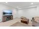 Bright living room with TV, console, and comfortable sectional sofa on soft carpet at 10360 E 57Th Pl, Denver, CO 80238