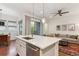 Open-concept kitchen and living area featuring island seating, modern finishes and natural light at 10360 E 57Th Pl, Denver, CO 80238