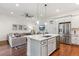 Open-concept kitchen and living space, featuring modern appliances, island, and comfortable seating at 10360 E 57Th Pl, Denver, CO 80238