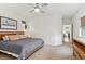 Primary bedroom with large bed, dresser and an en-suite bathroom at 10360 E 57Th Pl, Denver, CO 80238