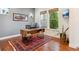 Bright office with wooden desk, large windows, and cozy rug at 10360 E 57Th Pl, Denver, CO 80238