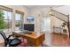 Comfortable home office setup with desk, chair, and natural light at 10360 E 57Th Pl, Denver, CO 80238