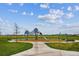 Community playground with a climbing structure and slide surrounded by lush green lawns at 10360 E 57Th Pl, Denver, CO 80238