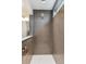 Modern shower featuring gray subway tile surround, white floor, and rain shower head at 10360 E 57Th Pl, Denver, CO 80238