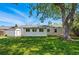 Well-manicured lawn with a storage shed and a charming home facade in the serene backyard at 2751 S Elm St, Denver, CO 80222