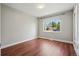 Empty bedroom with wood floors, window, and neutral walls, offering a blank canvas at 2751 S Elm St, Denver, CO 80222