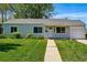 Charming single-story home features a well-manicured lawn and inviting entryway at 2751 S Elm St, Denver, CO 80222