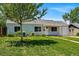 Traditional single-story home with lush front yard and a mature tree at 2751 S Elm St, Denver, CO 80222