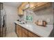 Bright kitchen features wood cabinets, quartz countertops, and lots of natural light at 2751 S Elm St, Denver, CO 80222