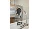 Practical laundry area with a stackable washer and dryer near a sink and counter space at 2751 S Elm St, Denver, CO 80222