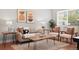 Cozy living room boasts neutral tones, wood accents, and plush seating for relaxation and entertainment at 2751 S Elm St, Denver, CO 80222