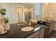 Bright bathroom featuring dual vanities with granite countertops and a glass shower at 1056 S Elk Way, Aurora, CO 80018