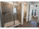 Modern bathroom showcasing a tiled glass shower and open doorway to toilet and bedroom at 1056 S Elk Way, Aurora, CO 80018