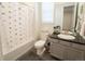 Cozy bathroom featuring a toilet and sink with a black and white shower curtain at 1056 S Elk Way, Aurora, CO 80018